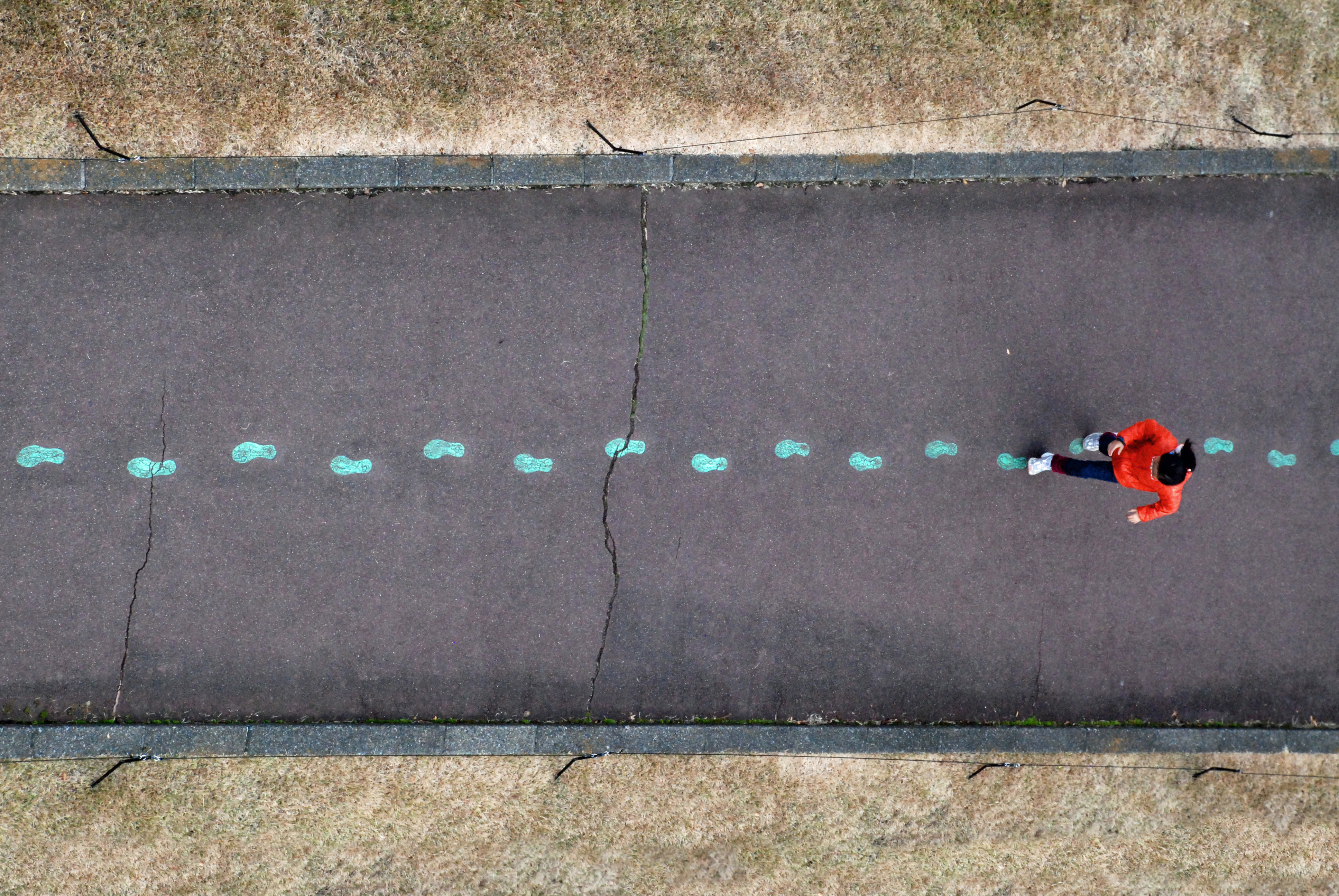 image showing person walking in pre-painted footprints